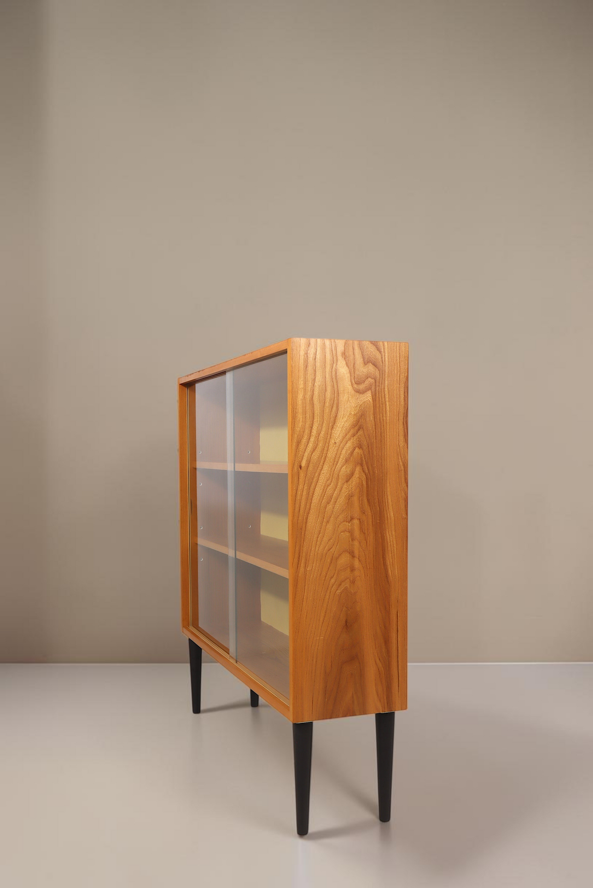 Vintage Space Hellerau Mid Century Vitrine mit Glasschiebetüren und senfgelber Rückwand in Seitenansicht